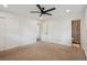 Neutral bedroom with ceiling fan, carpet flooring, and an ensuite bathroom at 4634 W Tufts Cir, Denver, CO 80236
