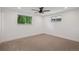 Spacious bedroom with carpet, fan, and two windows providing natural light at 4634 W Tufts Cir, Denver, CO 80236