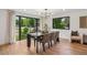 Bright dining room with hardwood floors, contemporary lighting and windows with green neighborhood views at 4634 W Tufts Cir, Denver, CO 80236