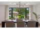Dining room featuring contemporary lighting, a large window with neighborhood views, and seating for six at 4634 W Tufts Cir, Denver, CO 80236