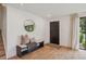 Welcoming entryway featuring hardwood floors, a stylish bench, and a contemporary mirror at 4634 W Tufts Cir, Denver, CO 80236
