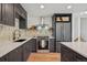 Well-appointed kitchen with updated appliances, granite countertops, and custom tile backsplash at 4634 W Tufts Cir, Denver, CO 80236