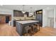 Updated kitchen with large center island, stainless appliances, and hardwood floors at 4634 W Tufts Cir, Denver, CO 80236