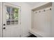 Mudroom features a door to the outside and built-in coat hooks and bench at 4634 W Tufts Cir, Denver, CO 80236
