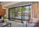 Living room view to backyard featuring a large patio and mature trees at 4634 W Tufts Cir, Denver, CO 80236