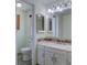 Well-lit bathroom featuring white vanity, mosaic tile backsplash, and neutral wall color at 5759 E Geddes Cir, Centennial, CO 80112