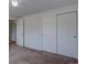 Bedroom featuring sliding door closets, neutral walls, and carpet flooring at 5759 E Geddes Cir, Centennial, CO 80112