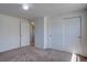 Bedroom featuring sliding door closets, neutral walls, and carpet flooring at 5759 E Geddes Cir, Centennial, CO 80112