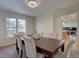 Inviting dining room featuring a wooden table with cushioned chairs and abundant natural light at 5759 E Geddes Cir, Centennial, CO 80112