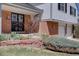 Close-up of a home's brick exterior with a security door, a garden, and garage at 5759 E Geddes Cir, Centennial, CO 80112