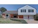 Charming home featuring a well-manicured lawn, brick accents, and an attached two-car garage at 5759 E Geddes Cir, Centennial, CO 80112
