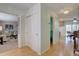 Bright hallway with hardwood floors, closet and views to a living room and dining area at 5759 E Geddes Cir, Centennial, CO 80112