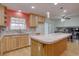 Open kitchen features light wood cabinets, large island, and access to the dining area at 5759 E Geddes Cir, Centennial, CO 80112