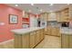 Eat in kitchen with light wood cabinets, light countertops, large island, and stainless steel appliances at 5759 E Geddes Cir, Centennial, CO 80112