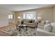 Comfortable living room with a bay window, plush furniture, and a decorative rug at 5759 E Geddes Cir, Centennial, CO 80112
