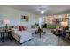 Open-concept living room with large windows, fireplace, comfortable seating and ceiling fan at 5759 E Geddes Cir, Centennial, CO 80112