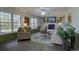 Open-concept living room with large windows, built in shelving and a ceiling fan at 5759 E Geddes Cir, Centennial, CO 80112