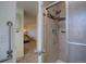 Modern bathroom with walk-in shower, grab bars, and neutral tile surround at 5759 E Geddes Cir, Centennial, CO 80112