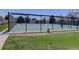 Well-maintained tennis court featuring a green and blue surface, surrounded by a black fence for privacy and safety at 5759 E Geddes Cir, Centennial, CO 80112