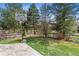 Backyard area features a basketball hoop on a concrete pad and a lush lawn at 762 Hughes Ln, Highlands Ranch, CO 80126