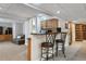 Finished basement with a bar area featuring seating and additional storage cabinets at 762 Hughes Ln, Highlands Ranch, CO 80126