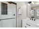 Modern bathroom featuring a sleek glass shower and vanity with marble countertop and black hardware at 762 Hughes Ln, Highlands Ranch, CO 80126