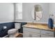 Charming half-bath with granite counters, dark blue wainscoting and updated fixtures offering a functional space at 762 Hughes Ln, Highlands Ranch, CO 80126