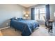 Comfortable bedroom with a large window for natural light and desk space for work or study at 762 Hughes Ln, Highlands Ranch, CO 80126