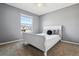 Bright bedroom with a large window, soft natural light, and neutral-toned carpet at 762 Hughes Ln, Highlands Ranch, CO 80126