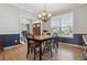 Dining room with modern chandelier, wainscoting detail, and hardwood floors at 762 Hughes Ln, Highlands Ranch, CO 80126