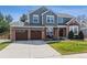 Beautiful two-story home featuring a brick and siding facade with a three-car garage at 762 Hughes Ln, Highlands Ranch, CO 80126