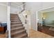 Spacious foyer featuring staircase, wood floors, and views into adjacent living spaces at 762 Hughes Ln, Highlands Ranch, CO 80126