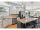 Spacious kitchen area with a large island, stainless steel appliances, light cabinets, and wood flooring at 762 Hughes Ln, Highlands Ranch, CO 80126