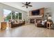 Cozy living room with brick fireplace, built-in shelving, and large windows for ample light at 762 Hughes Ln, Highlands Ranch, CO 80126