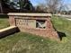 Stone sign reads Mansion Place with dinosaur, showing the entrance to a residential neighborhood at 762 Hughes Ln, Highlands Ranch, CO 80126