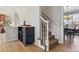 Hallway with stairway and cabinet area with view of open-concept dining room and an airy, bright atmosphere at 762 Hughes Ln, Highlands Ranch, CO 80126