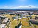 Breathtaking aerial view of the community, showcasing a golf course, ponds, and city skyline against snow capped mountains at 750 S Clinton St # 6B, Denver, CO 80247