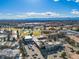 Expansive aerial view of a community featuring mature trees, green spaces, and distant mountain views under a clear blue sky at 750 S Clinton St # 6B, Denver, CO 80247