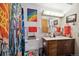 Eclectic bathroom with graffiti shower curtain and colorful artwork at 750 S Clinton St # 6B, Denver, CO 80247