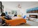 Bright bedroom with orange bedding and a fireplace at 750 S Clinton St # 6B, Denver, CO 80247