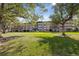 Apartment building exterior surrounded by trees and lawn at 750 S Clinton St # 6B, Denver, CO 80247