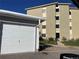 Apartment building with an adjacent garage and well-maintained landscaping at 750 S Clinton St # 6B, Denver, CO 80247