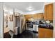 Well-lit kitchen featuring stainless steel appliances, contrasting dark countertops, and sleek black tile flooring at 750 S Clinton St # 6B, Denver, CO 80247