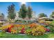 Landscaped courtyard with colorful flowers and a fountain at 750 S Clinton St # 6B, Denver, CO 80247