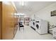 Bright and functional laundry room with multiple machines and convenient storage lockers at 750 S Clinton St # 6B, Denver, CO 80247