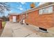 Brick exterior with a backyard patio area and white doors with the perfect blend of privacy and outdoor living at 6900 Avrum Dr, Denver, CO 80221