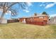 The backyard features a spacious grassy area, mature tree, and a private patio area at 6900 Avrum Dr, Denver, CO 80221