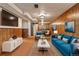 Cozy finished basement with wood paneling, living area, and dining set perfect for relaxing and entertaining at 6900 Avrum Dr, Denver, CO 80221