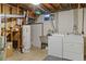 Utility basement area featuring modern washer and dryer, utility sink and hot water heater at 6900 Avrum Dr, Denver, CO 80221