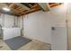 Utility basement with washer/dryer hookups, utility sink, and open ceiling at 6900 Avrum Dr, Denver, CO 80221